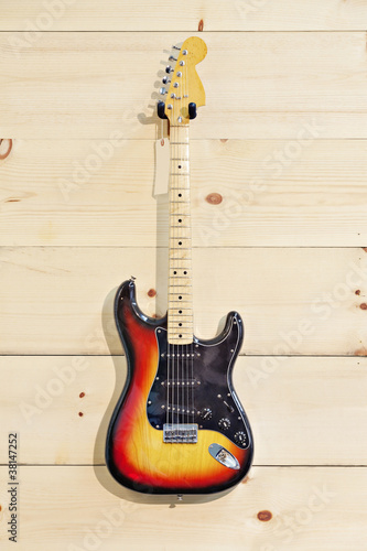 Photo: Acoustic guitar with label on wood grain wall Acoustic guitar with label on wood grain wall