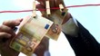 Male - Hanging money with pegs on a clothesline