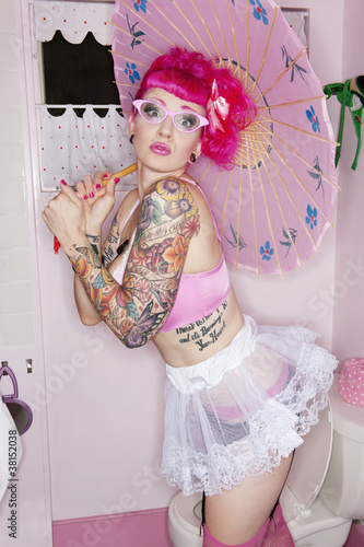 Photo: Tattooed woman in eyeglasses holding parasol Tattooed woman in eyeglasses holding parasol