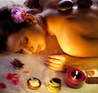 Young woman getting stones spa procedures.