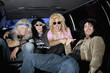 Cheerful male friends sitting in a limousine