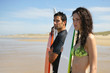Surfers staring at the horizon