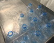 Worker pack large PET bottles. Plastic recycling.