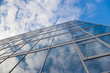 building with clouds reflection