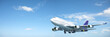 Jumbo jet aircraft is maneuvering in a blue sky. Panoramic compo