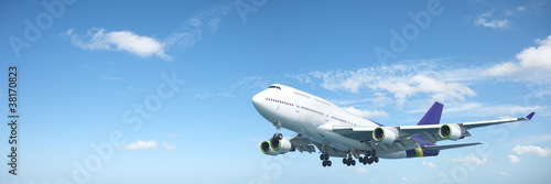 Photo: Jumbo jet aircraft is maneuvering in a blue sky. Panoramic compo Jumbo jet aircraft is maneuvering in a blue sky. Panoramic compo