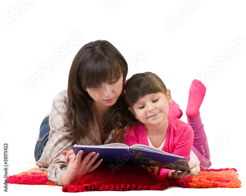 Photo: Mother and daughter reading a book on white background. Mother and daughter reading a book on white background.