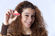 Foto: Young woman holding a small car Young woman holding a small car