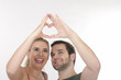 A happy couple showing the heart A happy couple showing the heart
