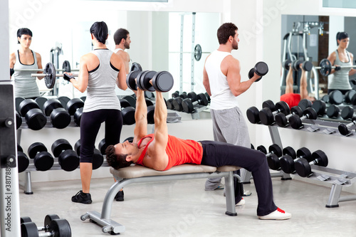 Photo: group of people in sport fitness gym weight training group of people in sport fitness gym weight training