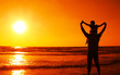 father and son on the sea on sunset