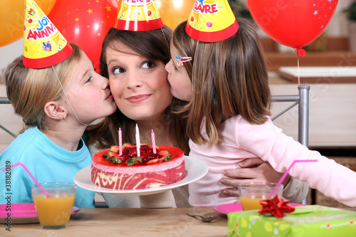 Photo: sisters kissing mom at birthday's party sisters kissing mom at birthday's party