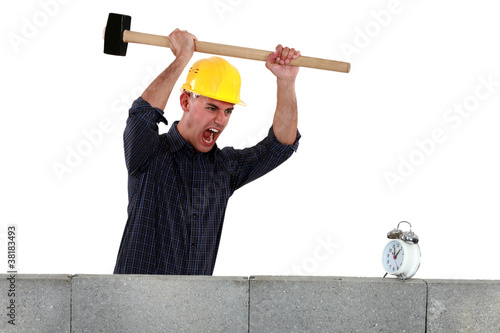 Photo: Tradesman about to smash an alarm clock Tradesman about to smash an alarm clock
