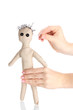 Voodoo doll boy in the hands of women isolated on white
