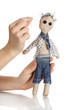 Voodoo doll boy in the hands of women isolated on white