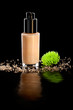 Photo: Closeup shot of foundation cream with a flower, on black Closeup shot of foundation cream with a flower, on black