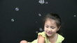 Little girl playing with bubbles