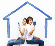Young couple with paint brushes together