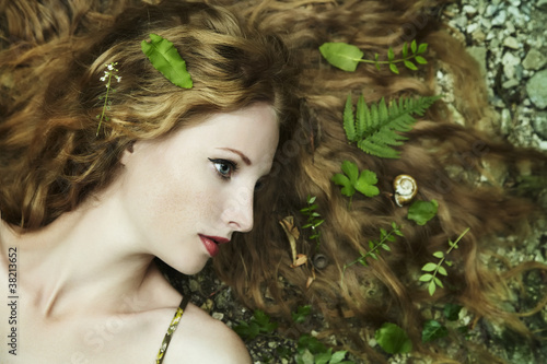 Photo: Fashion portrait of young sensual woman in garden Fashion portrait of young sensual woman in garden