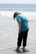 Teen Boy Stepping Into Ocean Surf