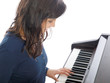 smiling teenage girl playing piano