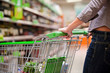 Photo: Female Shopper With Trolley at Supermarket Female Shopper With Trolley at Supermarket