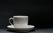 A white cup in front of black background A white cup in front of black background