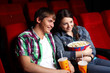 Foto: Young couple in cinema watching movie Young couple in cinema watching movie