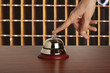Hand of a woman using a hotel bell