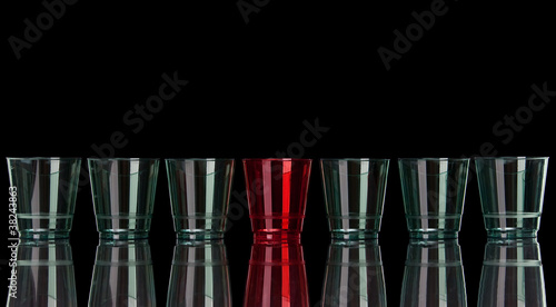 Photo: Straight row of colored plastic glasses on black with reflection Straight row of colored plastic glasses on black with reflection
