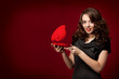 Happy girl opening a gift on Valentine's Day