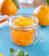 jar of homemade orange preserves with open lid
