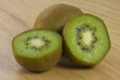 Close-up of 2 Kiwis with One Cut in Half on a Cutting Board Close-up of 2 Kiwis with One Cut in Half on a Cutting Board