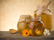 jar of honey and flowers on wood jar of honey and flowers on wood