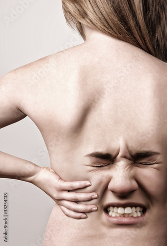 Photo: Woman with back pains Woman with back pains