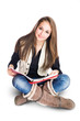 Cute young student girl sitting and reading.