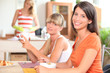 Three young women having breakfast at home