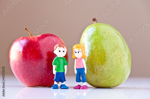 Photo: Girl and Boy Discussing Healthy Nutrition (Pear and Apple) Girl and Boy Discussing Healthy Nutrition (Pear and Apple)