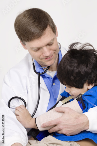 Photo: Male doctor holding five year old disabled patient Male doctor holding five year old disabled patient