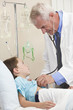 Young Boy Child Patient In Hospital Bed & Male Doctor