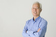 Portrait of an Asian senior businessman standing in front modern