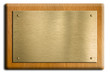 Wooden plaque with gold or brass plate isolated on white. Clippi