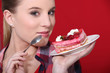 Woman holding up a scrumptious piece of cake