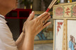 Pray, Chinese woman hold joss stick and praying at temple.