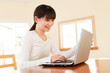 Photo: Beautiful asian woman using a laptop computer Beautiful asian woman using a laptop computer