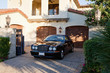Luxurious car parked in entrance gate of house