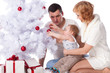 Photo: Happy family. Christmas tree. Happy family. Christmas tree.