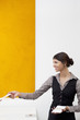 Young receptionist giving away templates