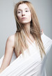 Foto: Alarmed gentle half-dressed girl in white clothes Alarmed gentle half-dressed girl in white clothes