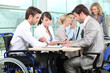 Man in wheelchair with colleagues in a meeting